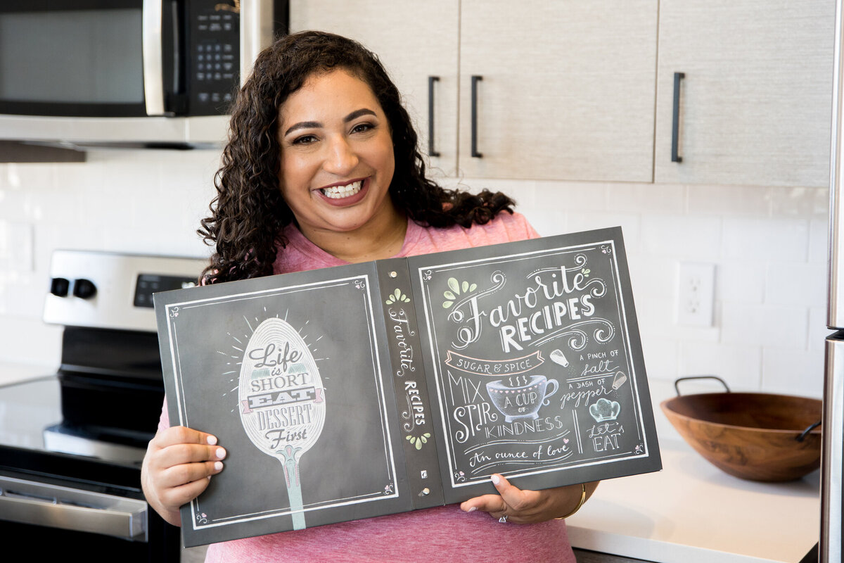 Heather’s cheerful moment with a cookbook, perfect for content on recipes and cooking joy. Ideal for blogs and social media about culinary interests and food tips.
