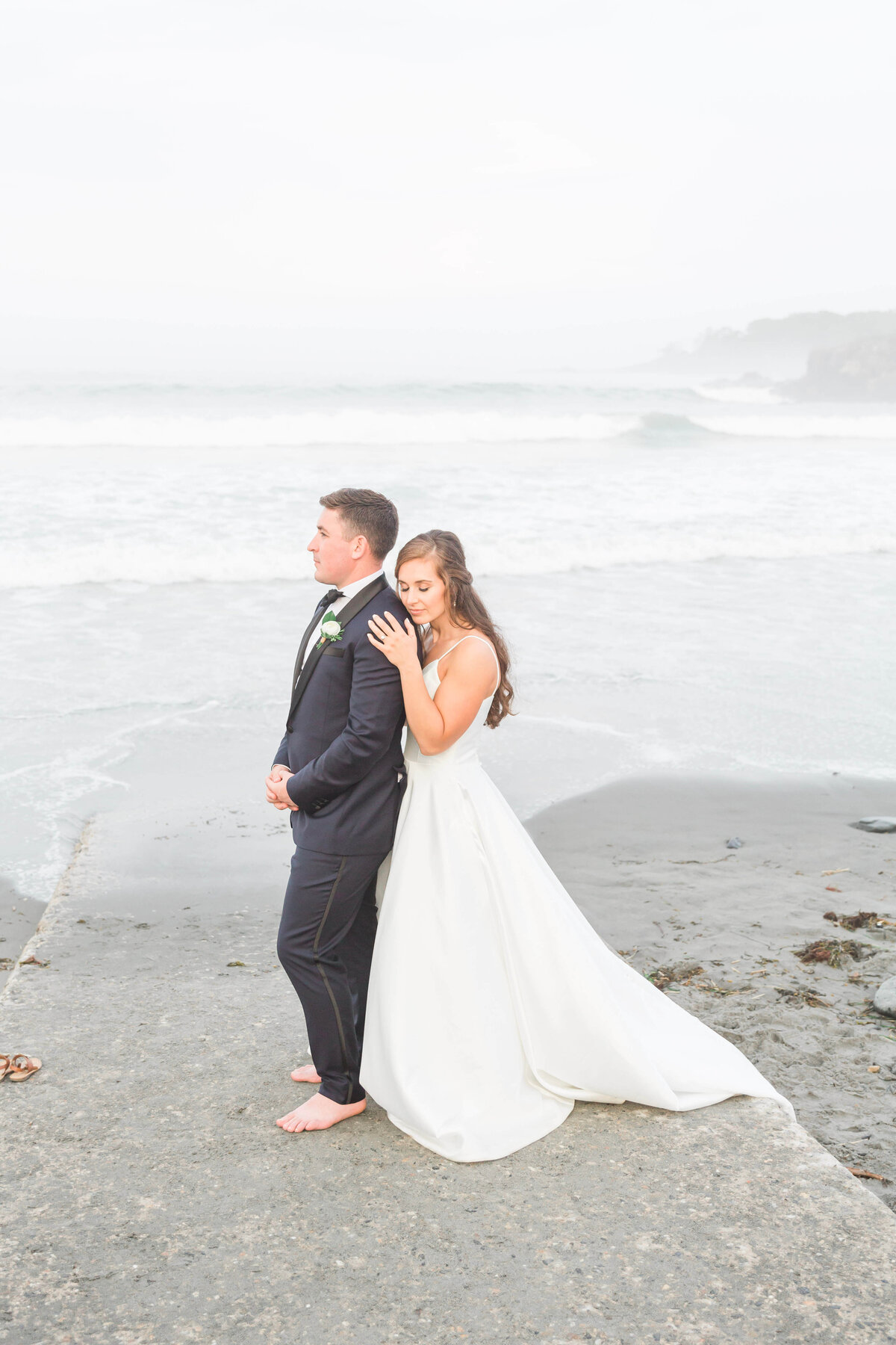 adventurous bride and groom standing on rocks at York Harbor beach for york Inn Wedding  (46)
