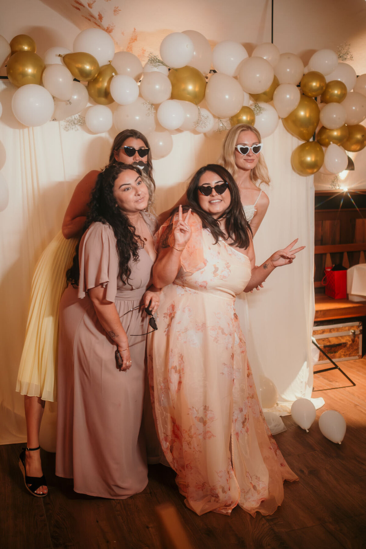Taking pictures on their own, wedding guests pose for the photo box.