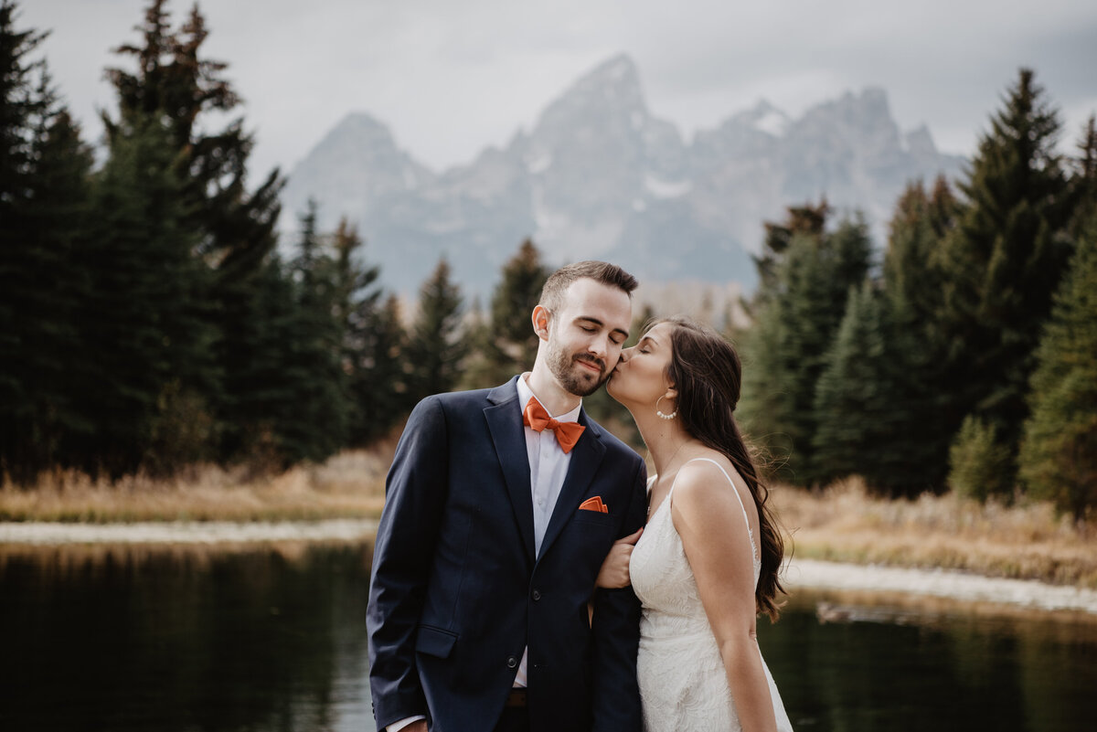 Photographers Jackson Hole capture bride kissing groom's cheek