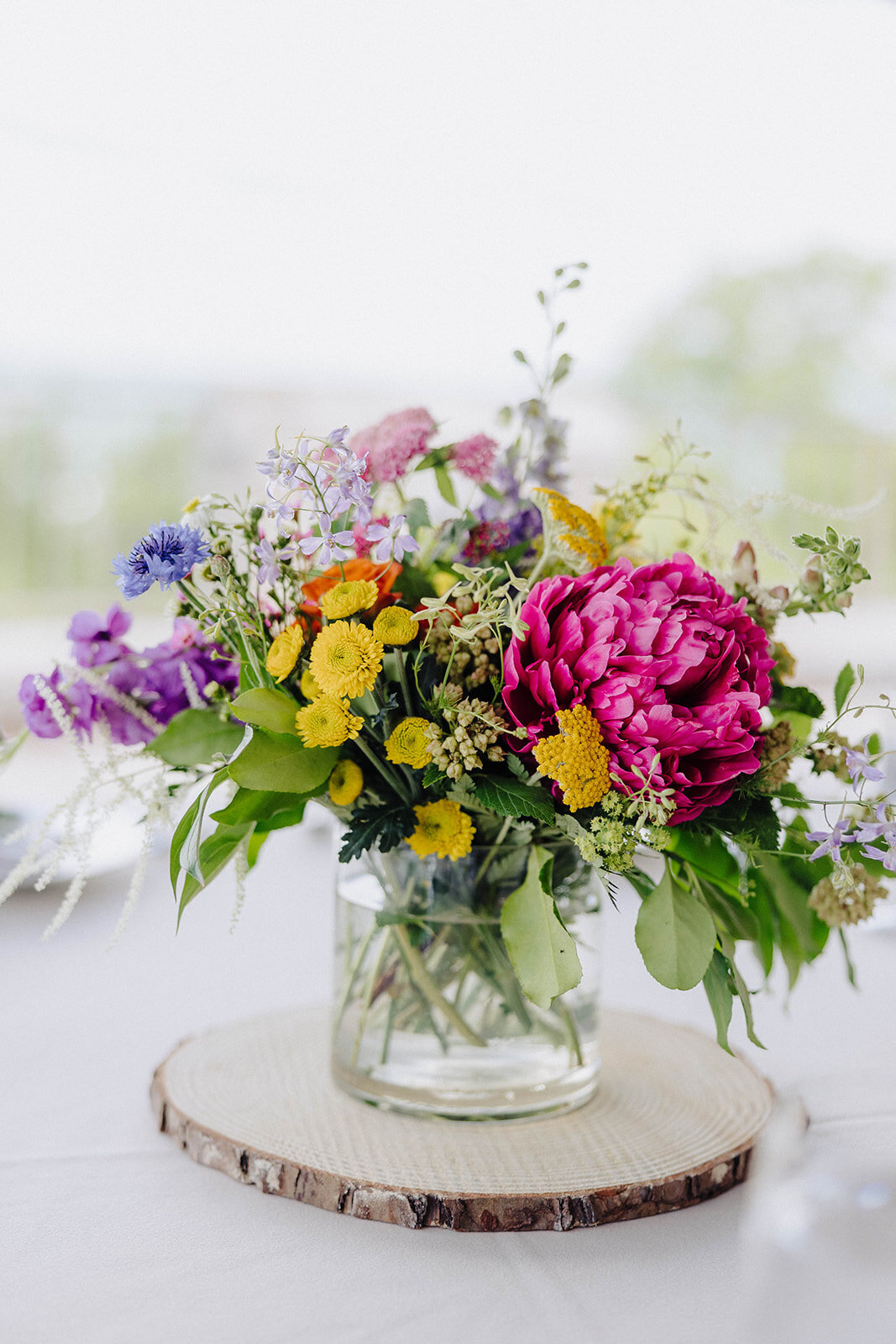 Bright florals set upon a table at Cornell University wedding