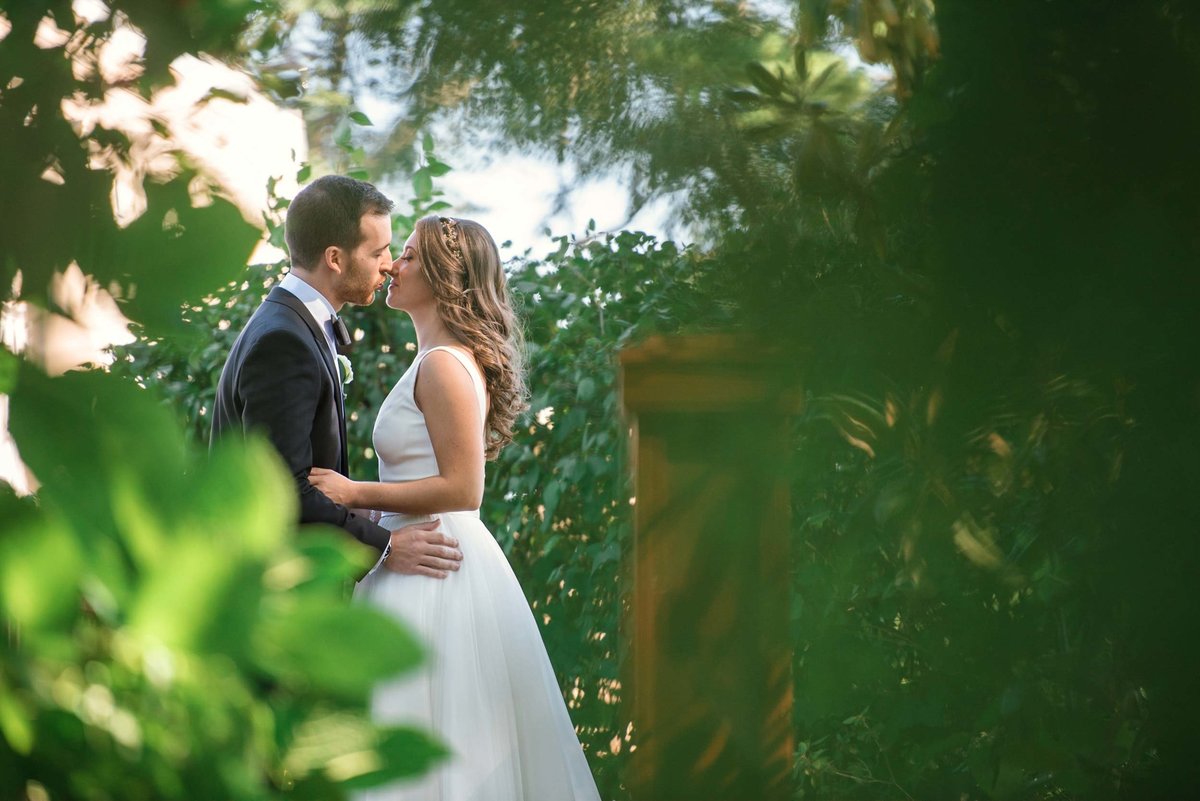 Bride and groom kiss in the outdoor area at Stonebridge Country Club