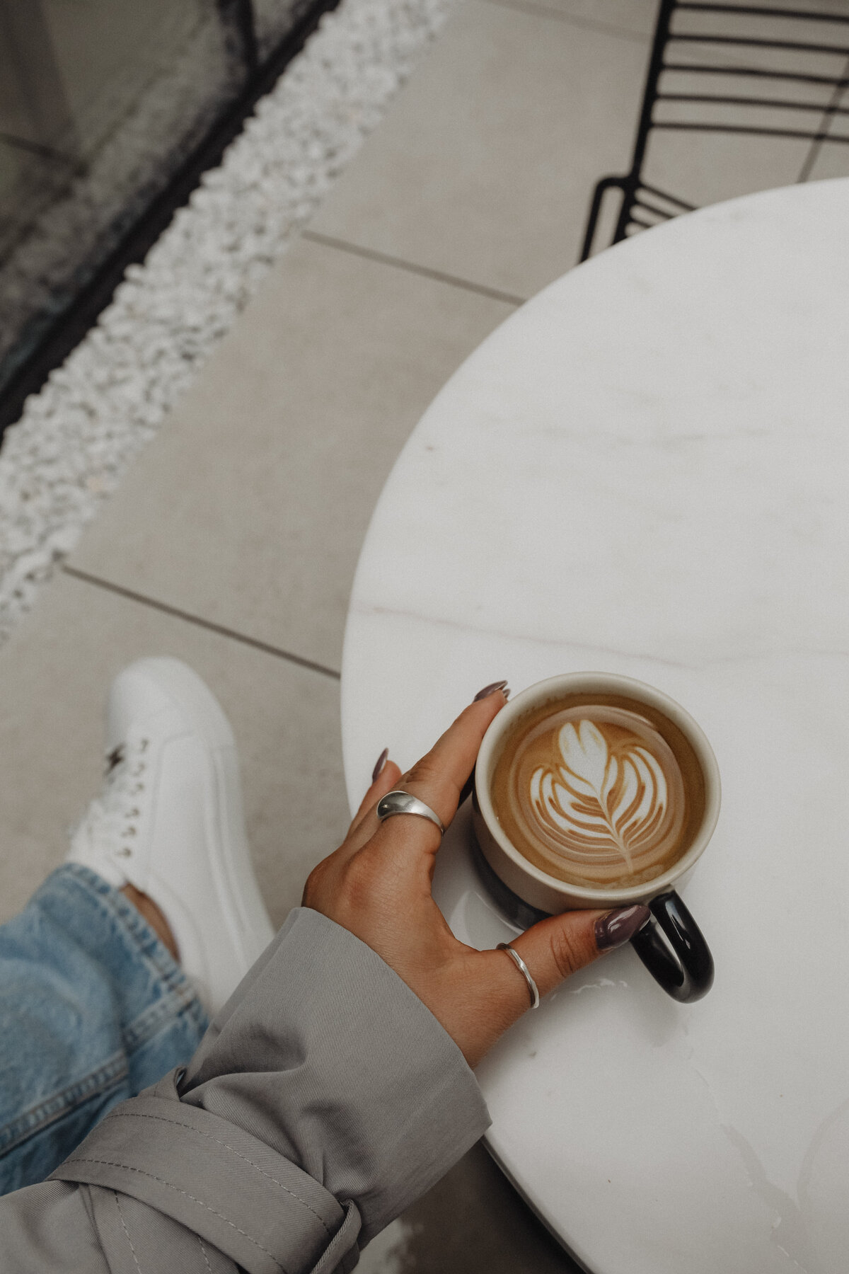 kaboompics_cozy-indoor-scene-woman-enjoying-a-cup-of-coffee-at-a-white-marble-table-32601