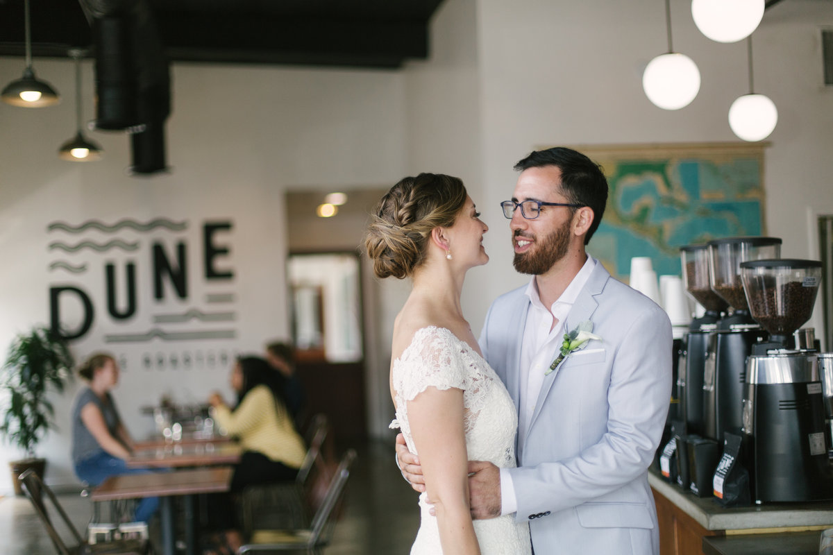 Bride looks at groom at French Press Coffee after Santa Barbara Courthouse wedding