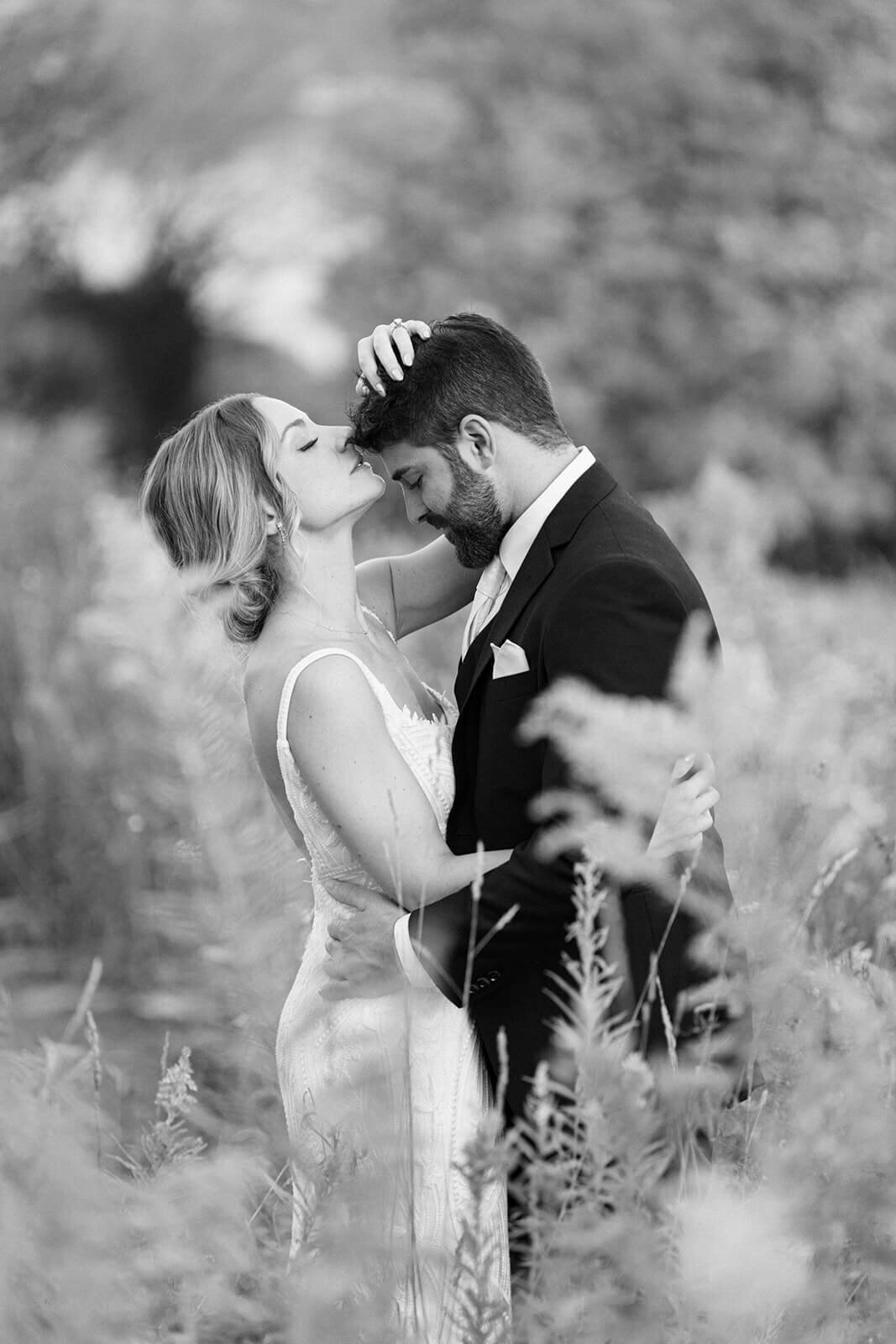 Bride kissing groom on the head at Finger Lakes Wedding, New York
