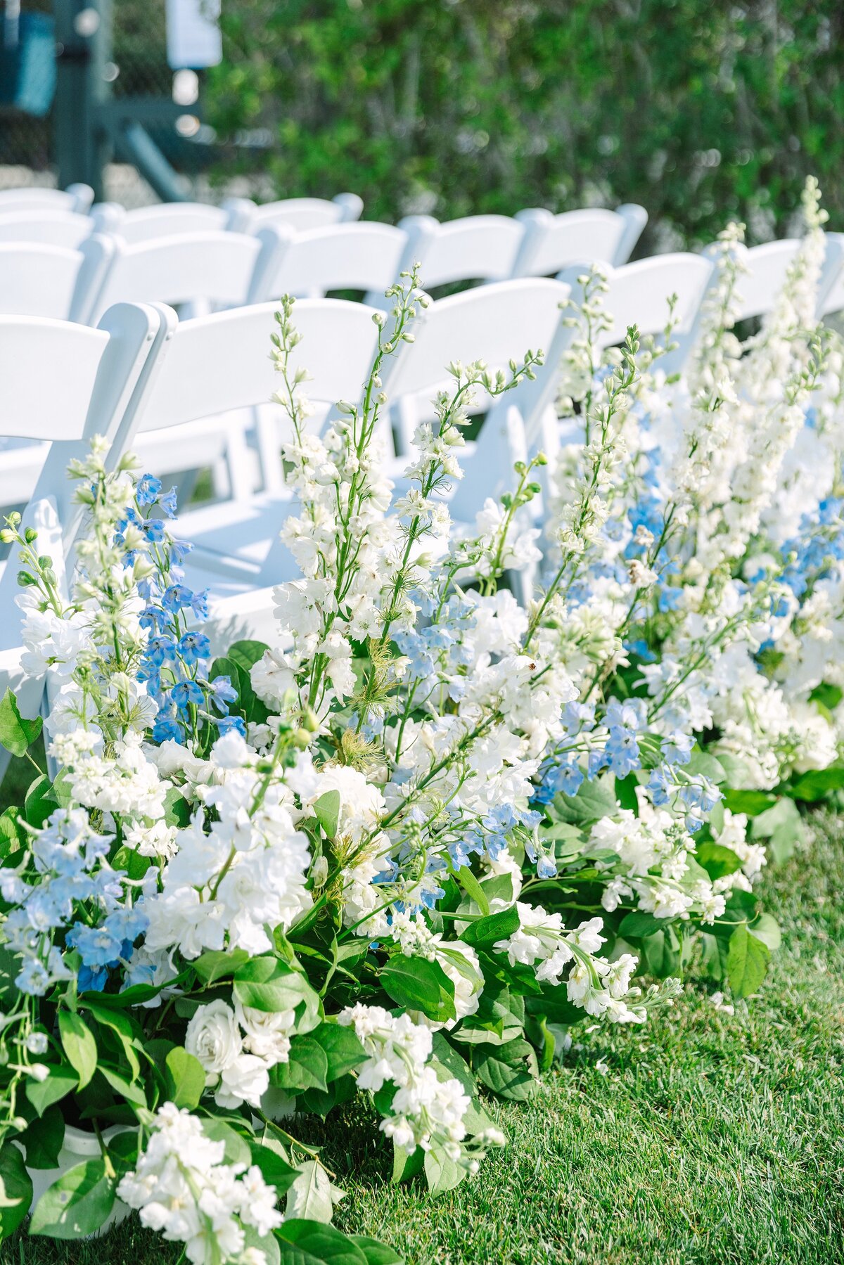 detail photo of blue and white floral arrangements at ceremony site