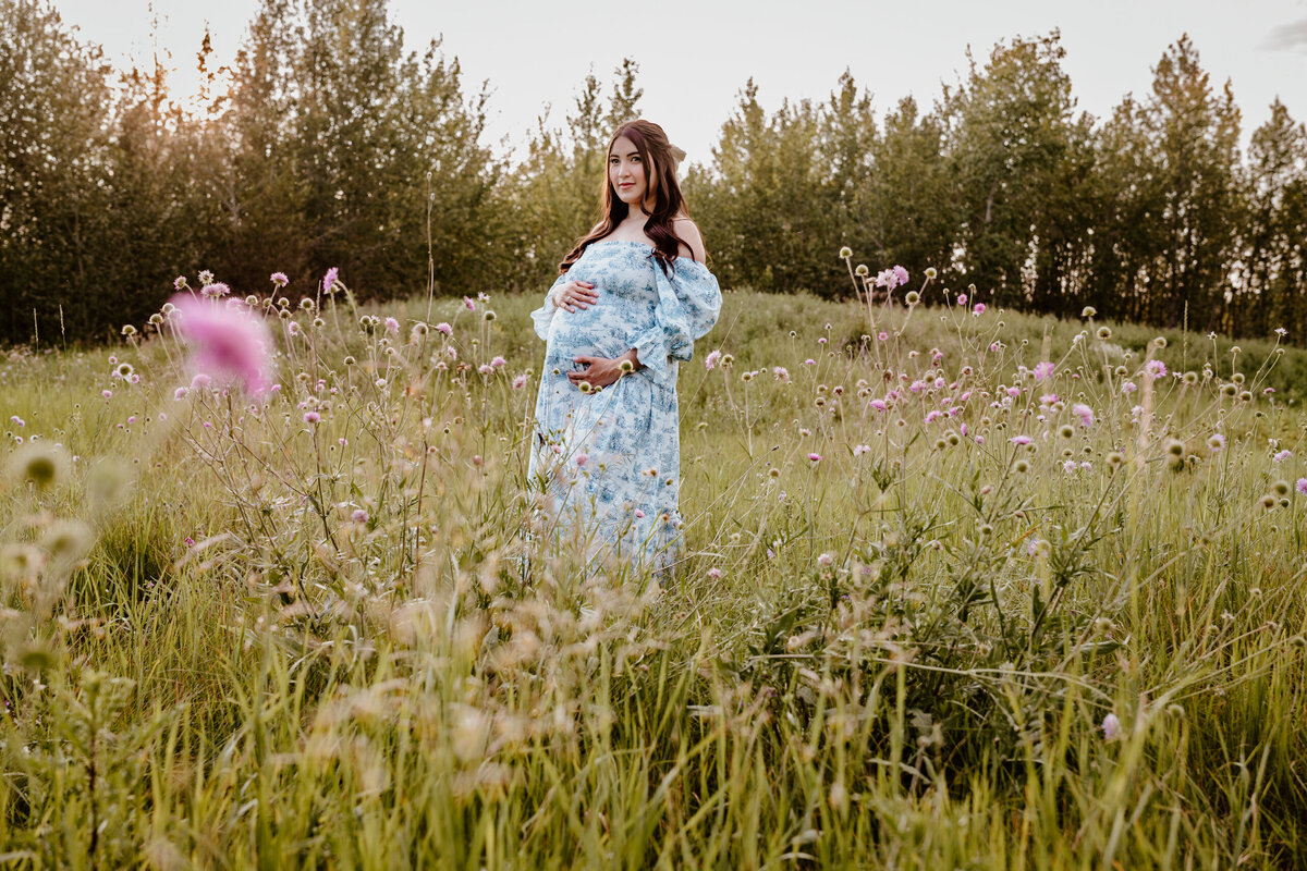 Maternity Pregnant Woman in field with flowers