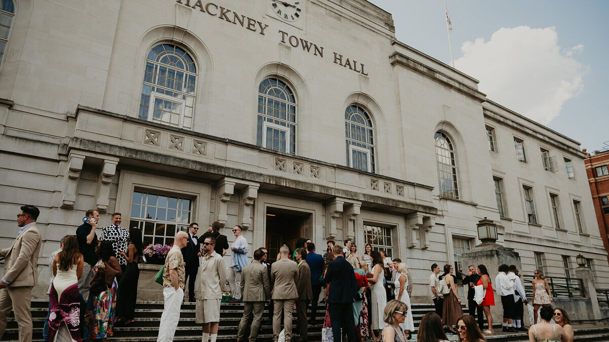 Wedding guests gather on the stairs at Hackney Town Hall in London. 