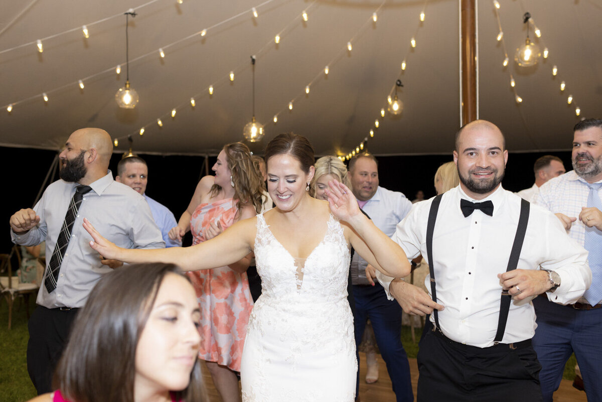 bride and groom dancing with friends at wedding reception - candlelight farms inn wedding