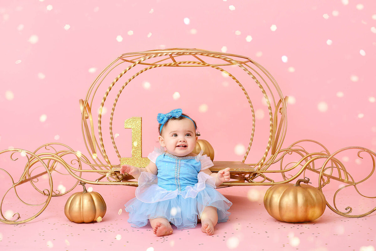 girl smiles at her girly first birthday photoshoot in houston