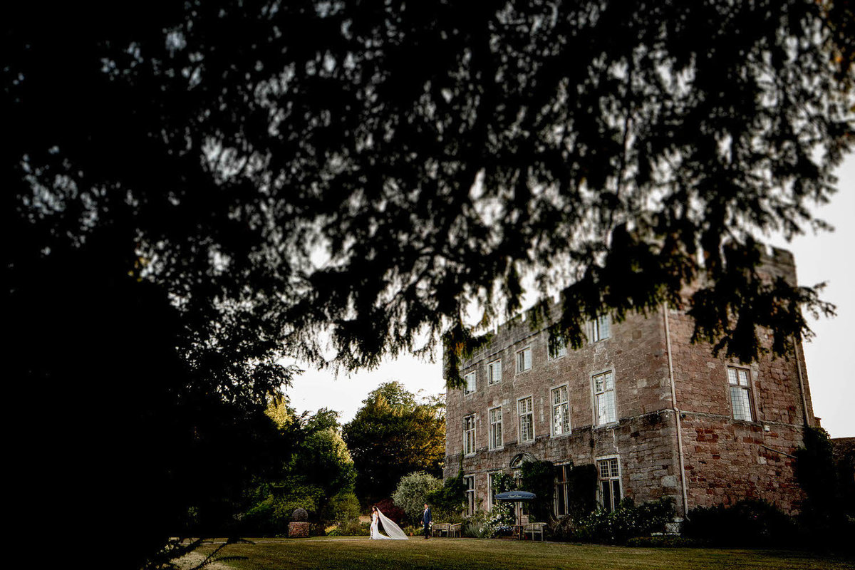 a wedding couple take a wlak in the the gardens of askham hall
