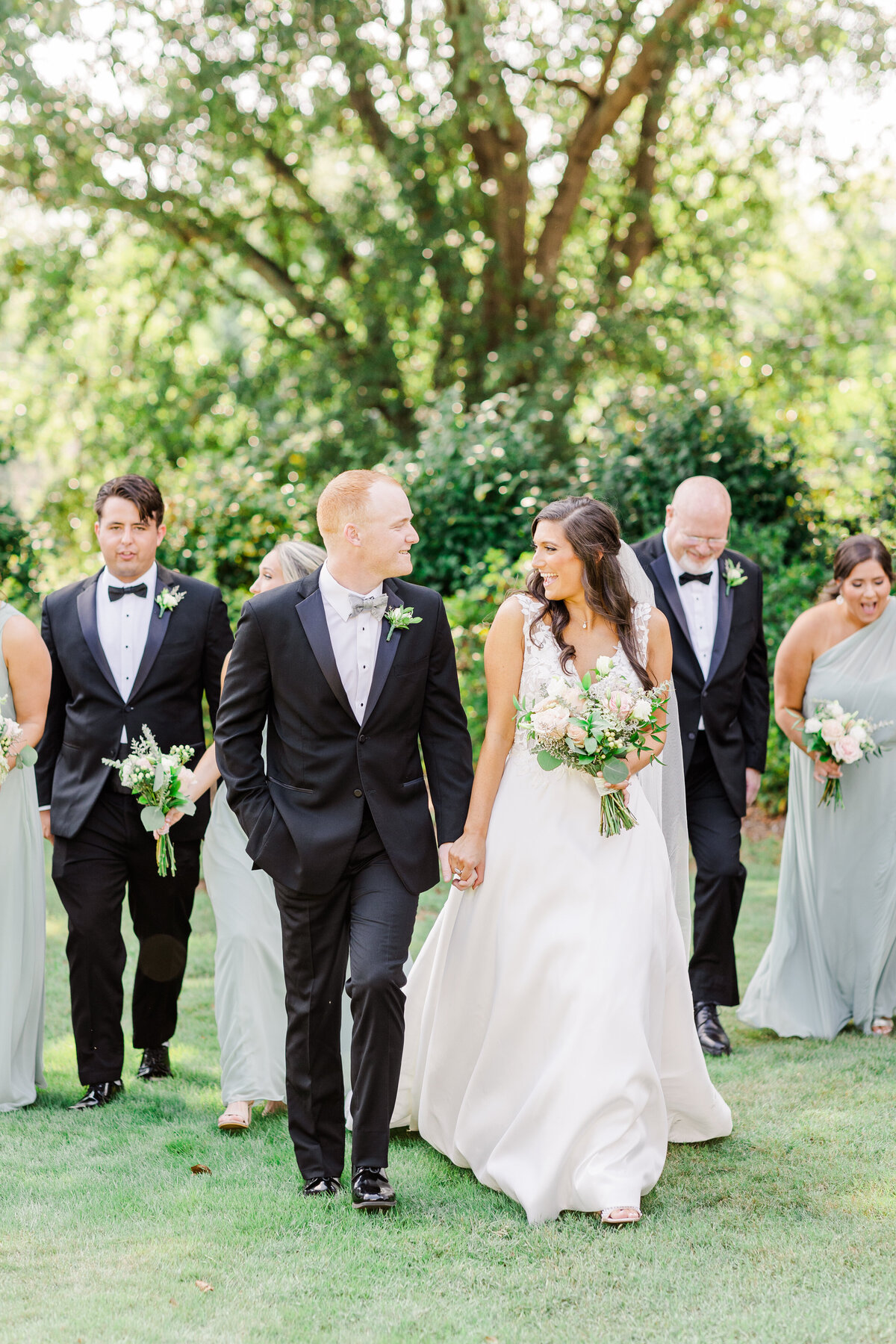 birde and groom standing with bridal party at outdoor SC wedding