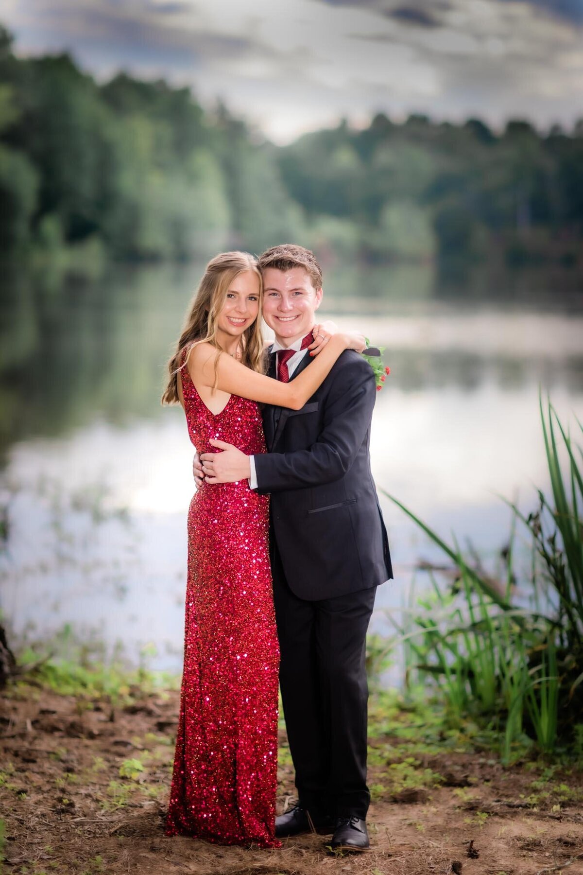 Prom date portrait for this couple wearing a red dress and tuxedo at Lake Peachtree in Peachtree City Georgia.