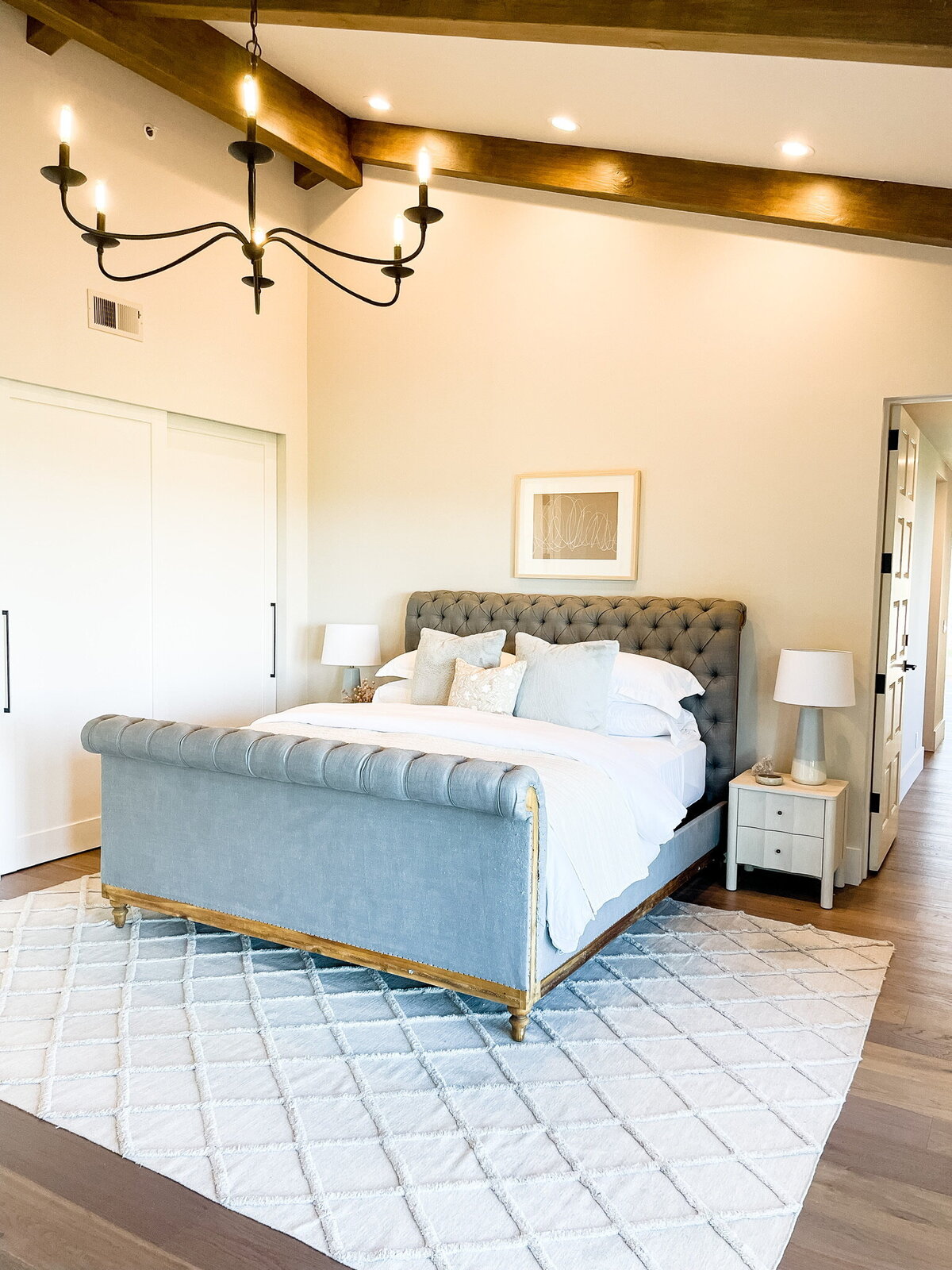 moody lighting napa inspired chandelier king size bed linear closet pulls petite natural wood nightstand neutral artwork