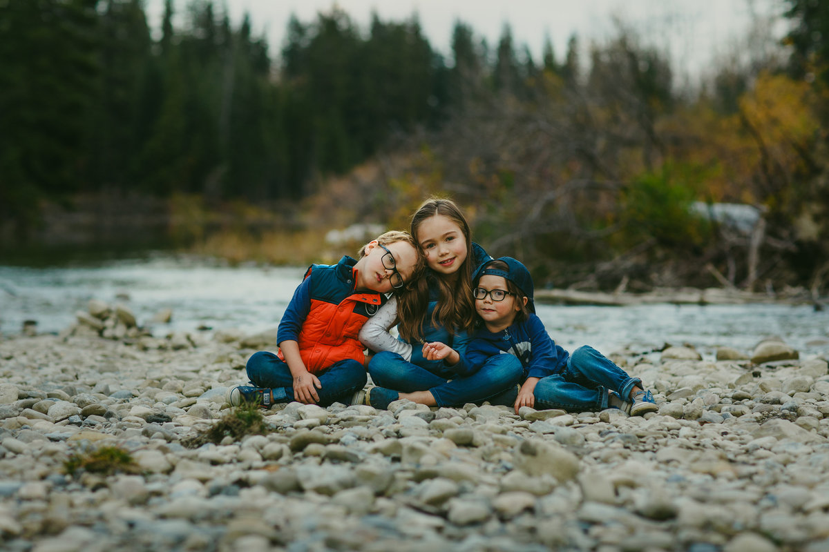 Portrait of three siblings on a waterbed