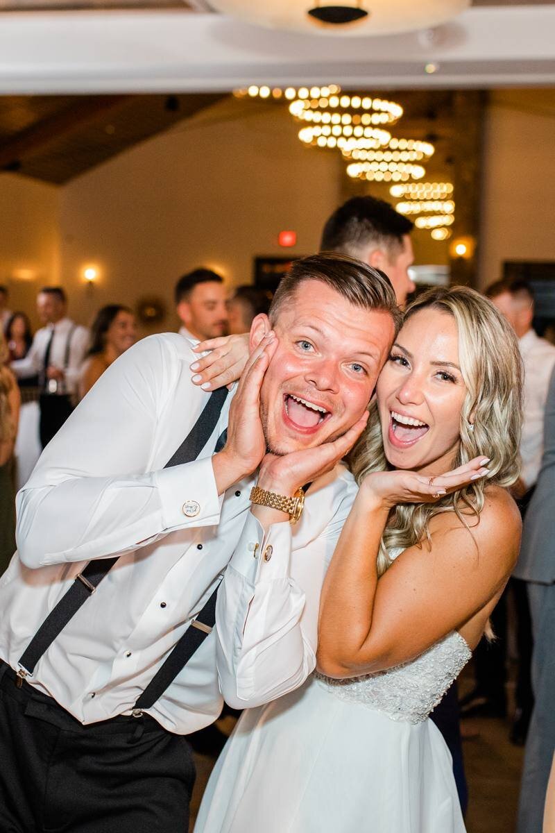 super cute photo of bride and groom cheesing at reception
