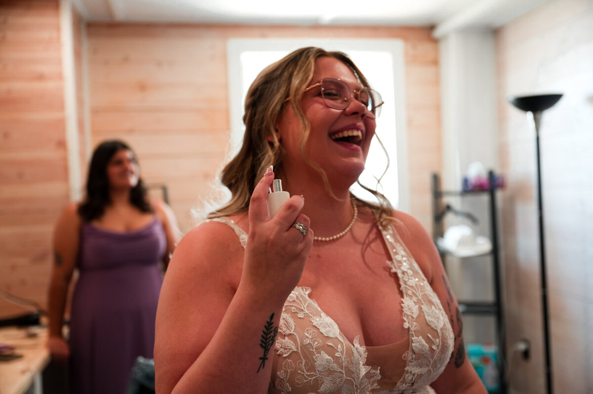 bride spraying perfume on wedding morning