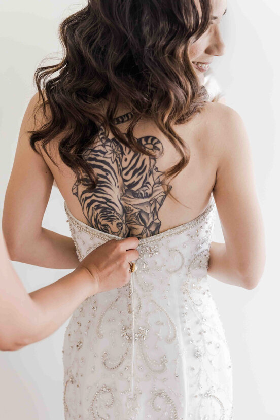 bride-getting-into-dress-tiger-tattoo