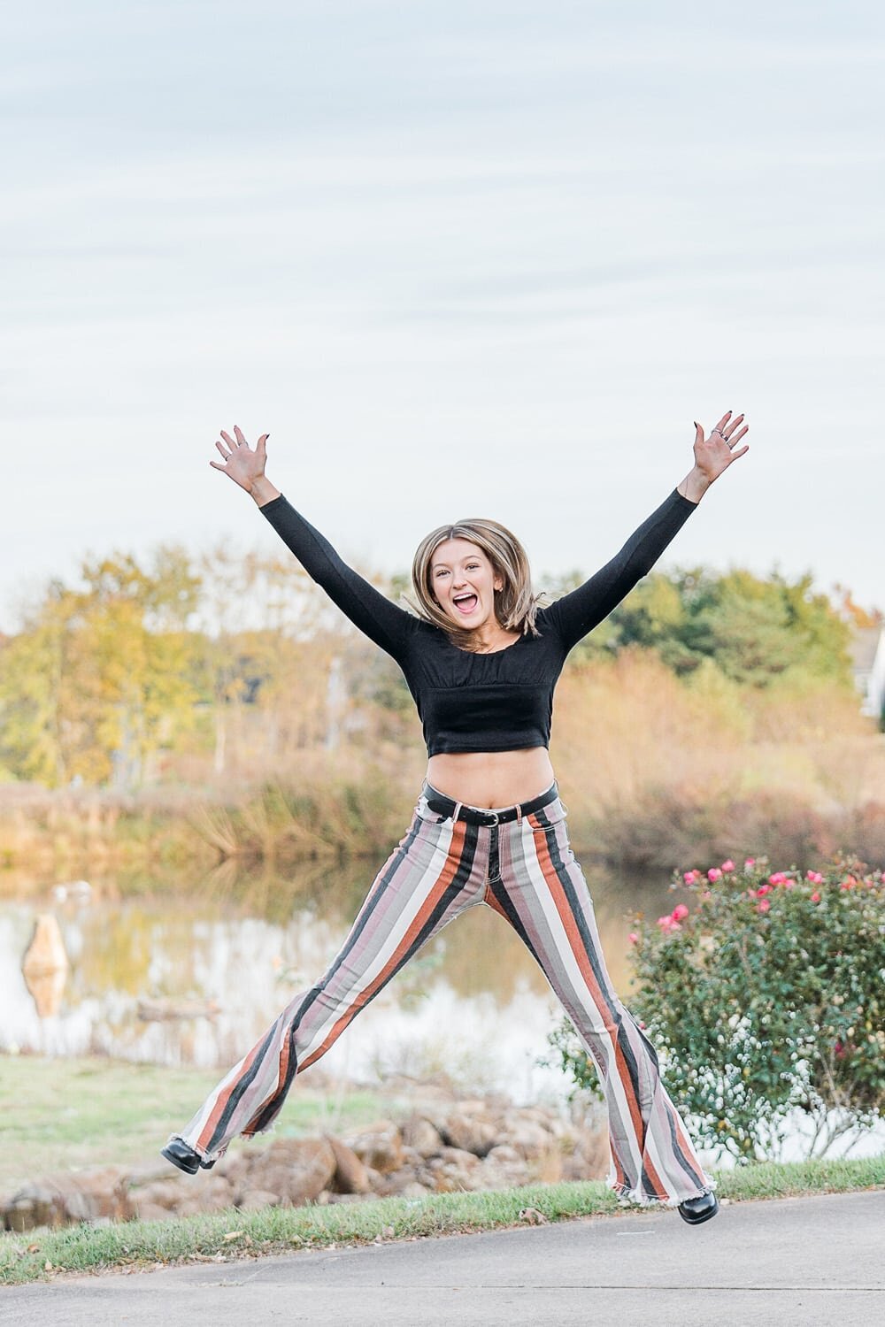 girl jumping for joy during Loudoun County, Virginia senior photography