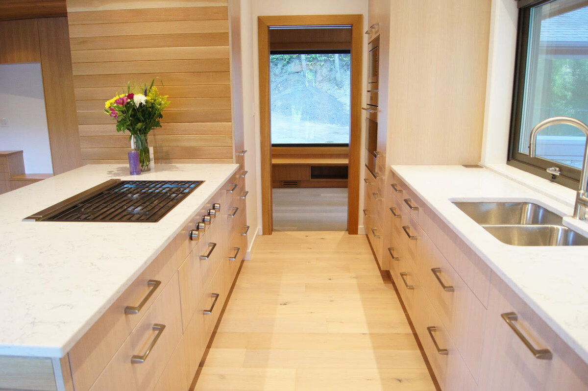 Kitchen interior design with integrated range and wall ovens.