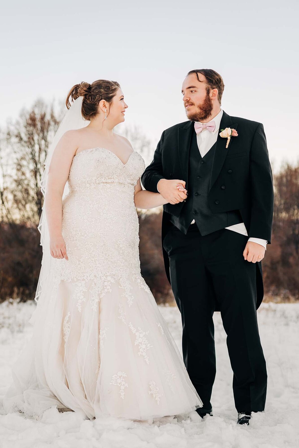 Bride and groom holding hands at winter wedding in Hamilton, MT