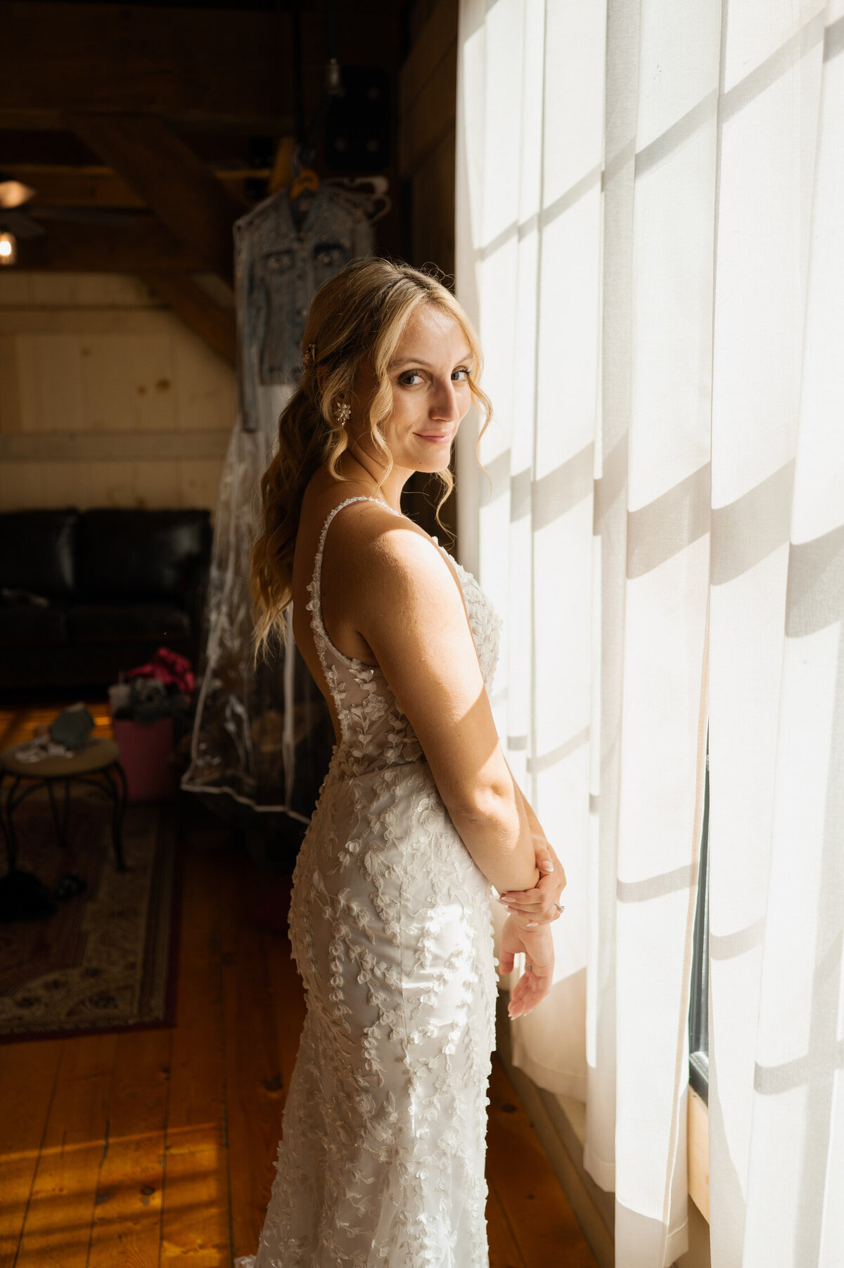 A portrait of the bride in the bridal suite before her wedding at Country Meadows Barn in Fort Ann, NY.