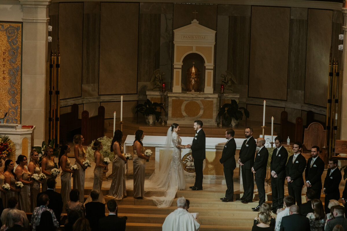 Wedding ceremony in a grand indoor setting, capturing vows in Indiana.