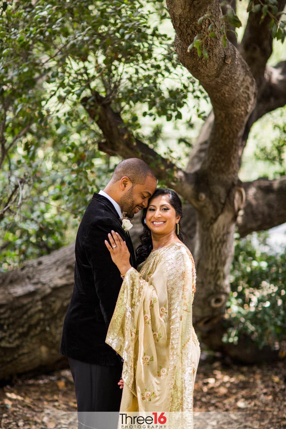 Sweet moment between Bride and Groom during photo session outside in garden area