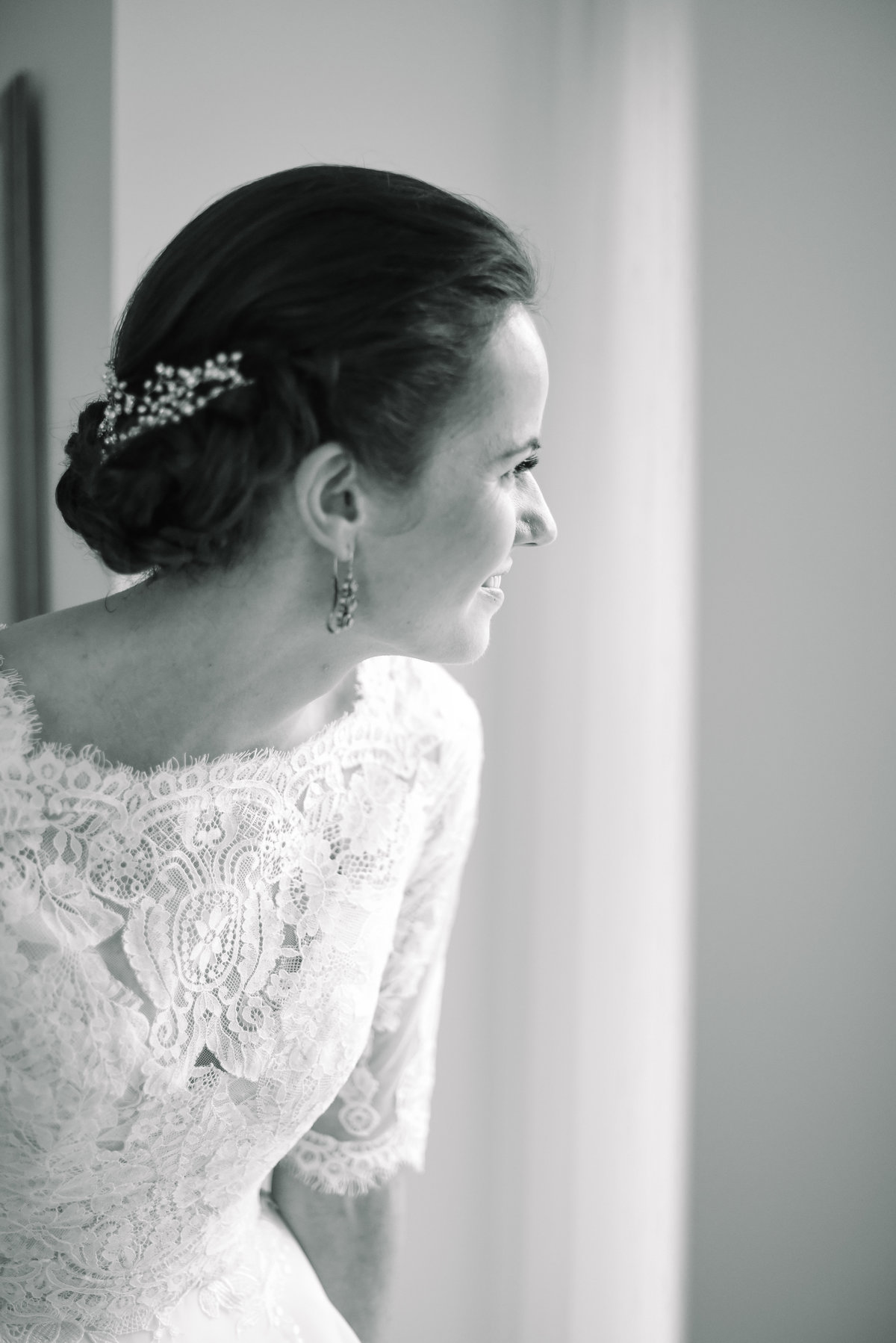 Bride looks out window before getting ready