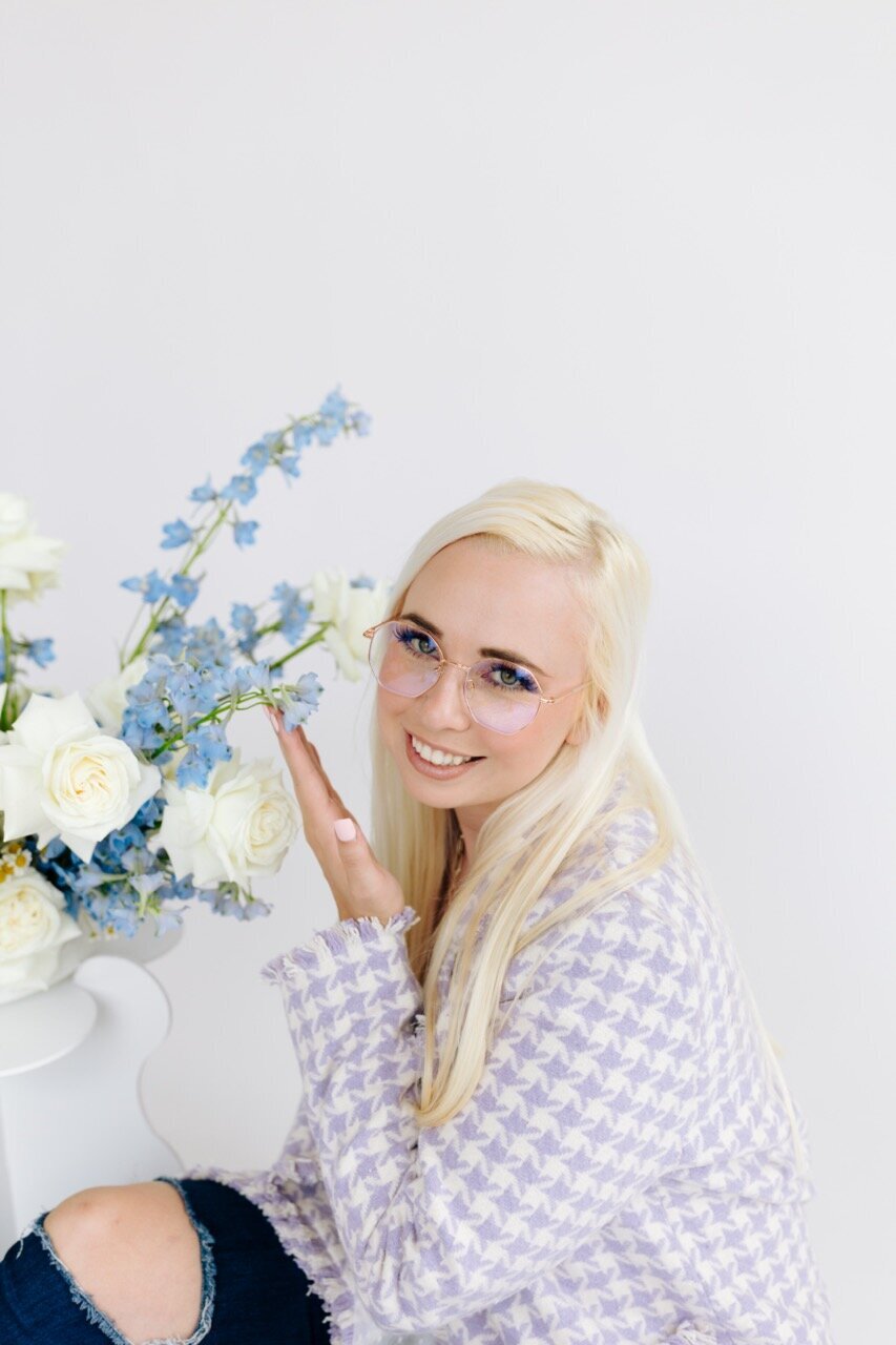 Designer smelling flowers
