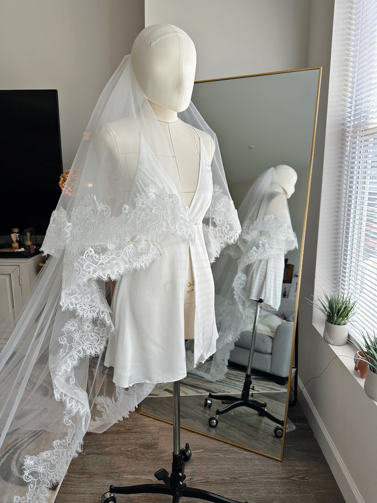 Classic ivory blusher veil featuring scalloped lace detailing
