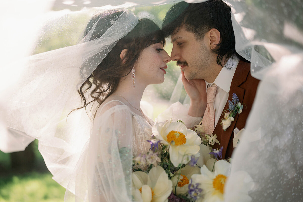 Bride and groom embracing during sunset wedding portraits at Record Box Loft