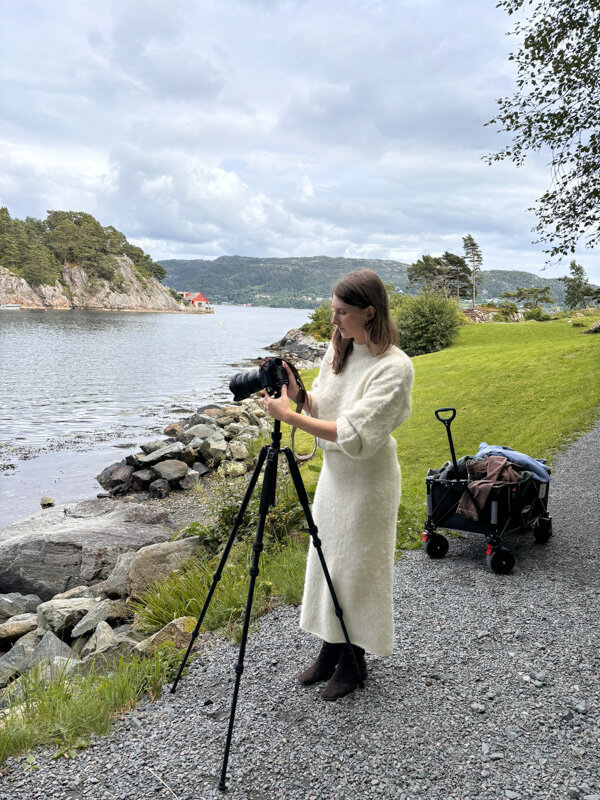 A female photographer is working on a beautiful location in Norway