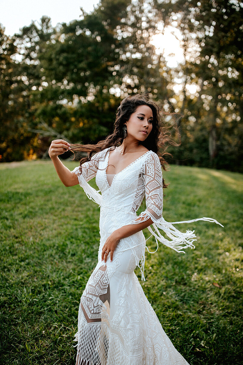 bride wearing a white wedding gown posing in the outdoors