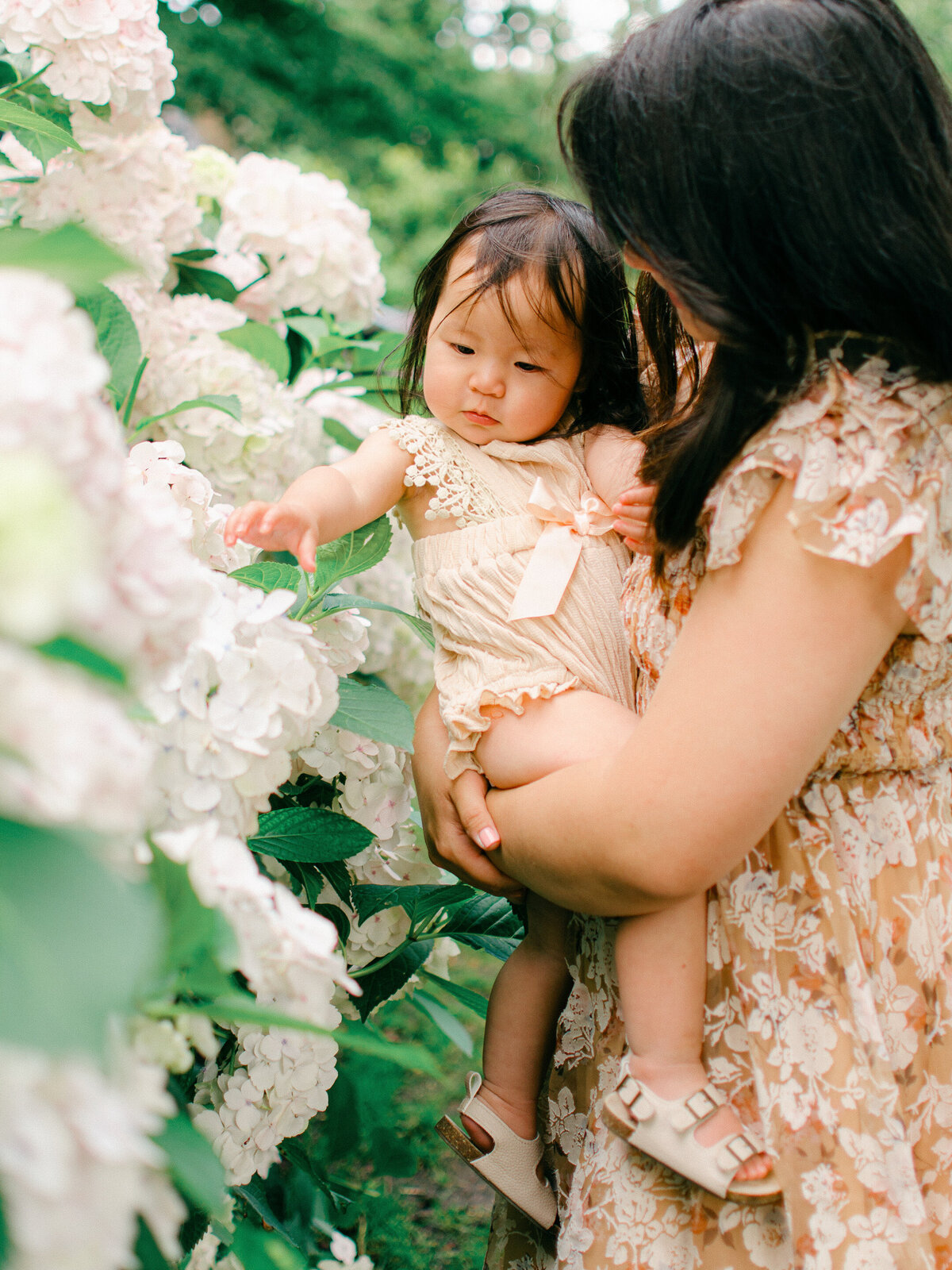 Mother and daughter look at flowers by Amsterdam Photographer, Sim Sawyers. 
