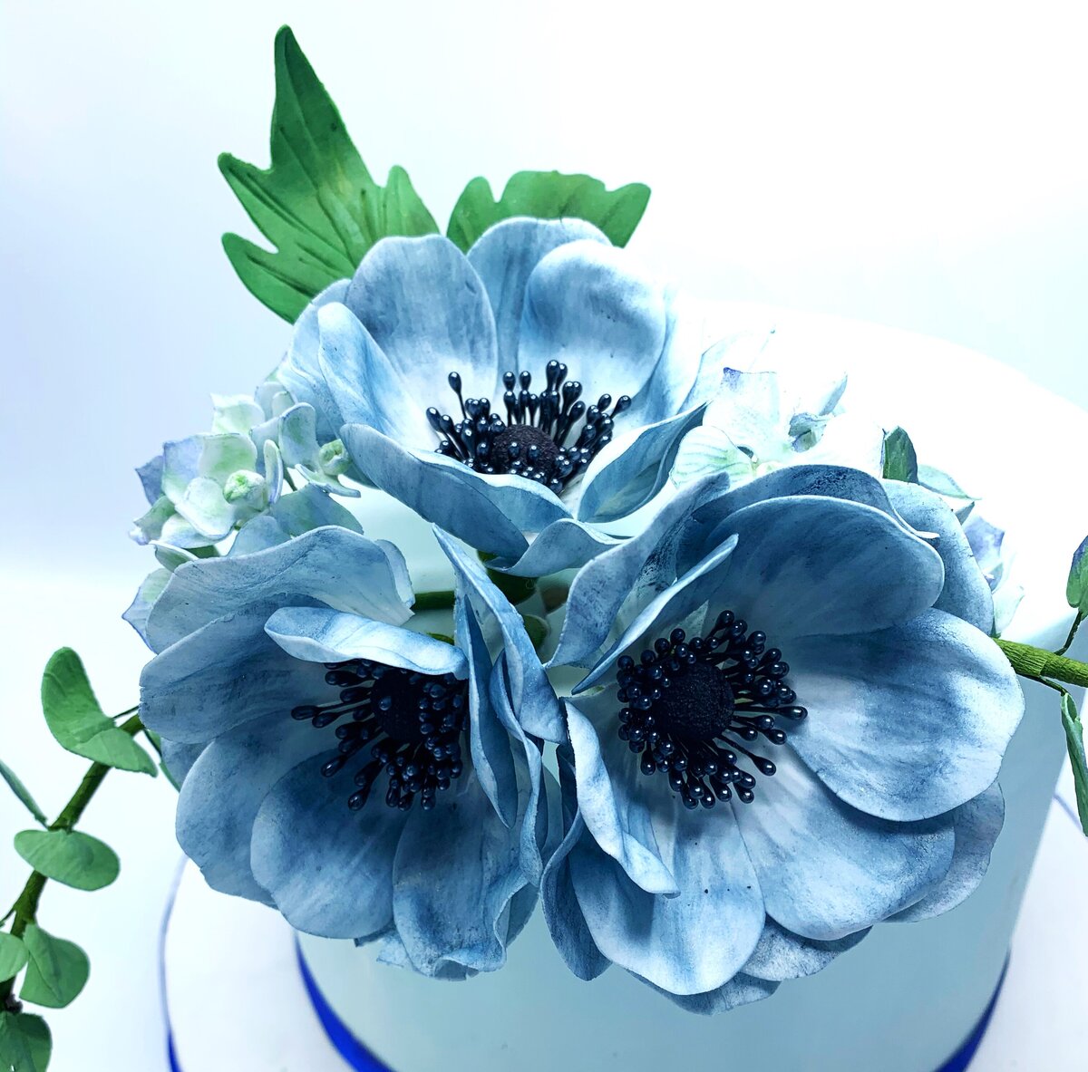 Blue anemone bouquet with leaves and eucalyptus