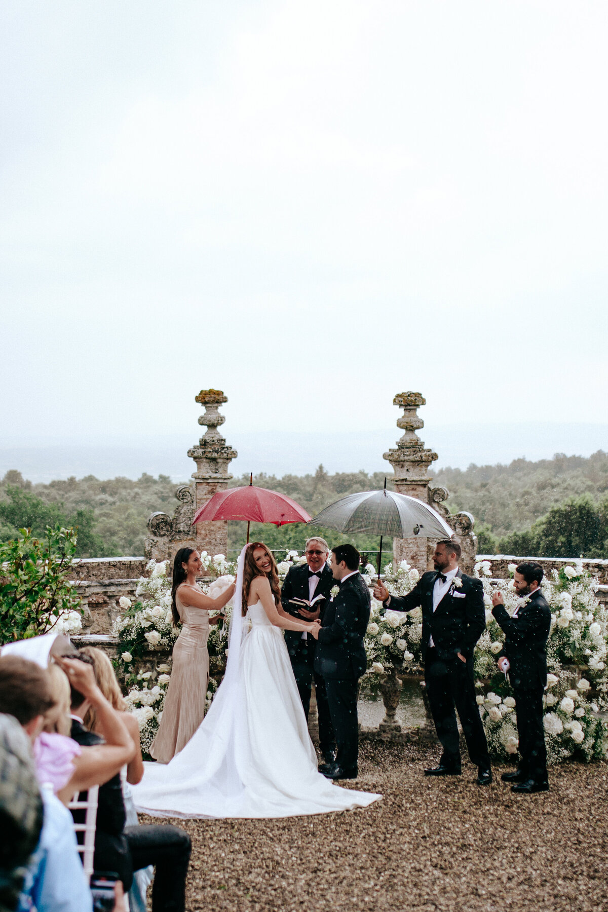 laughing bride during ceremony in the rain in Tuscany