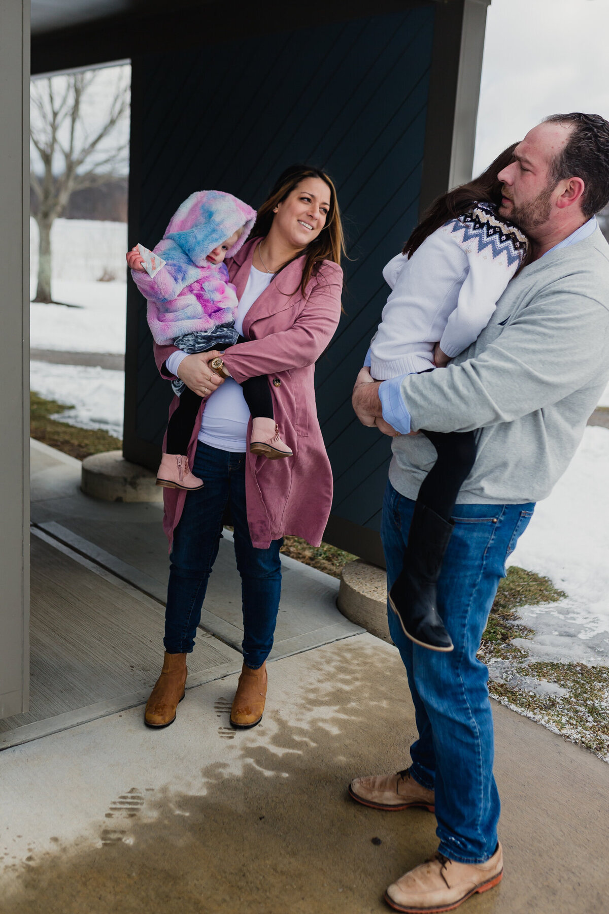 Maternity and family photoshoot with mom, dad, and two young girls.