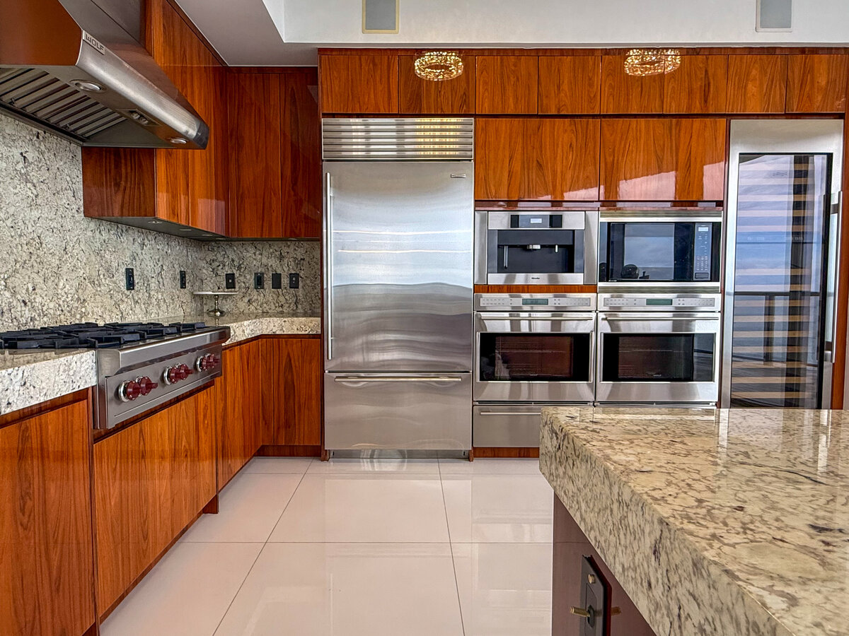 Sleek custom kitchen with chef-grade appliances and ocean views at PH-888