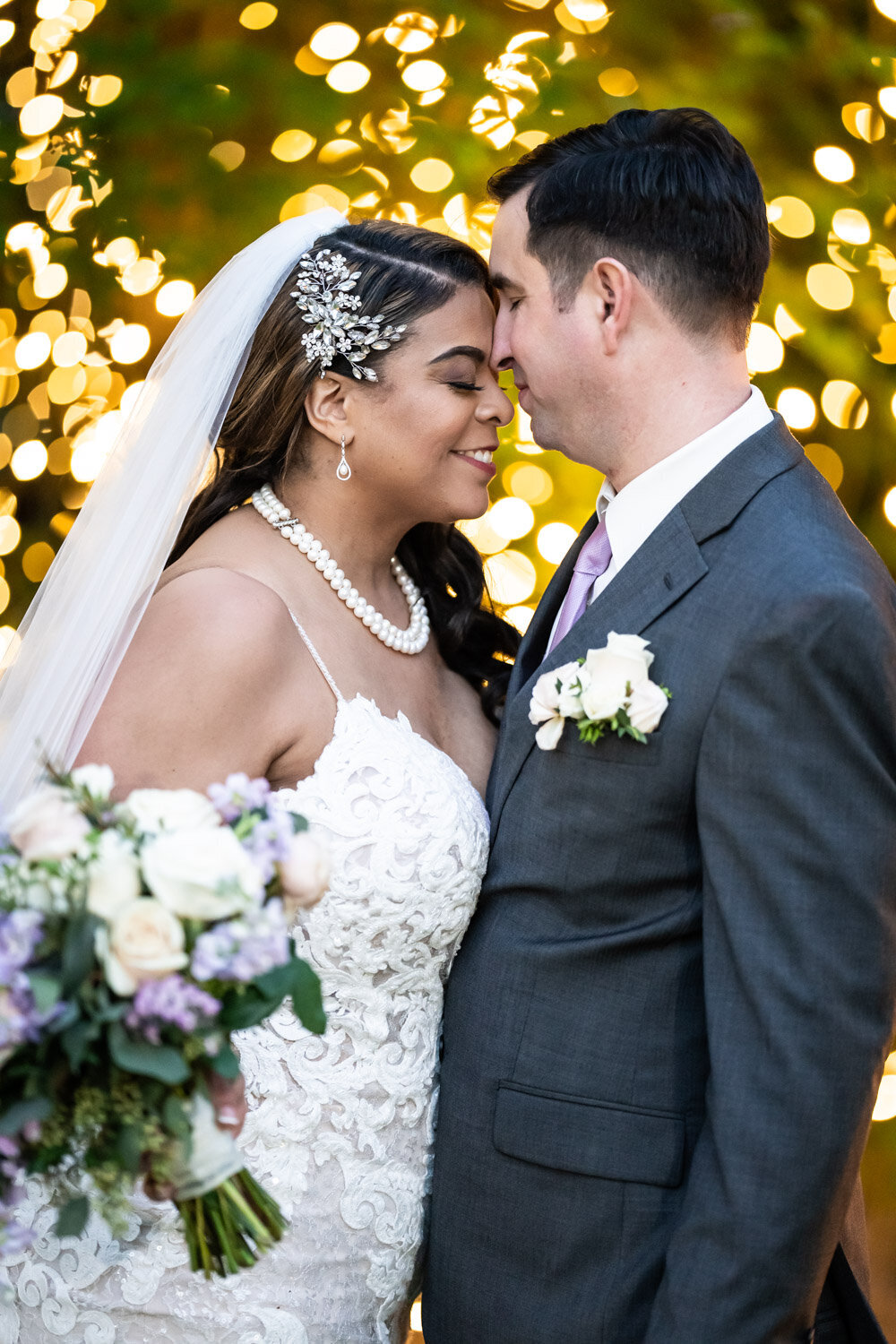 Couple embracing in front of twinkly lights