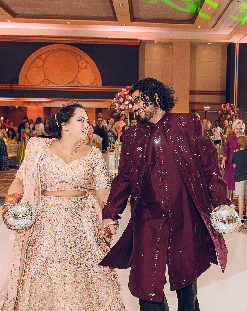 A couple celebrates their wedding reception following their mandap in Chicago 