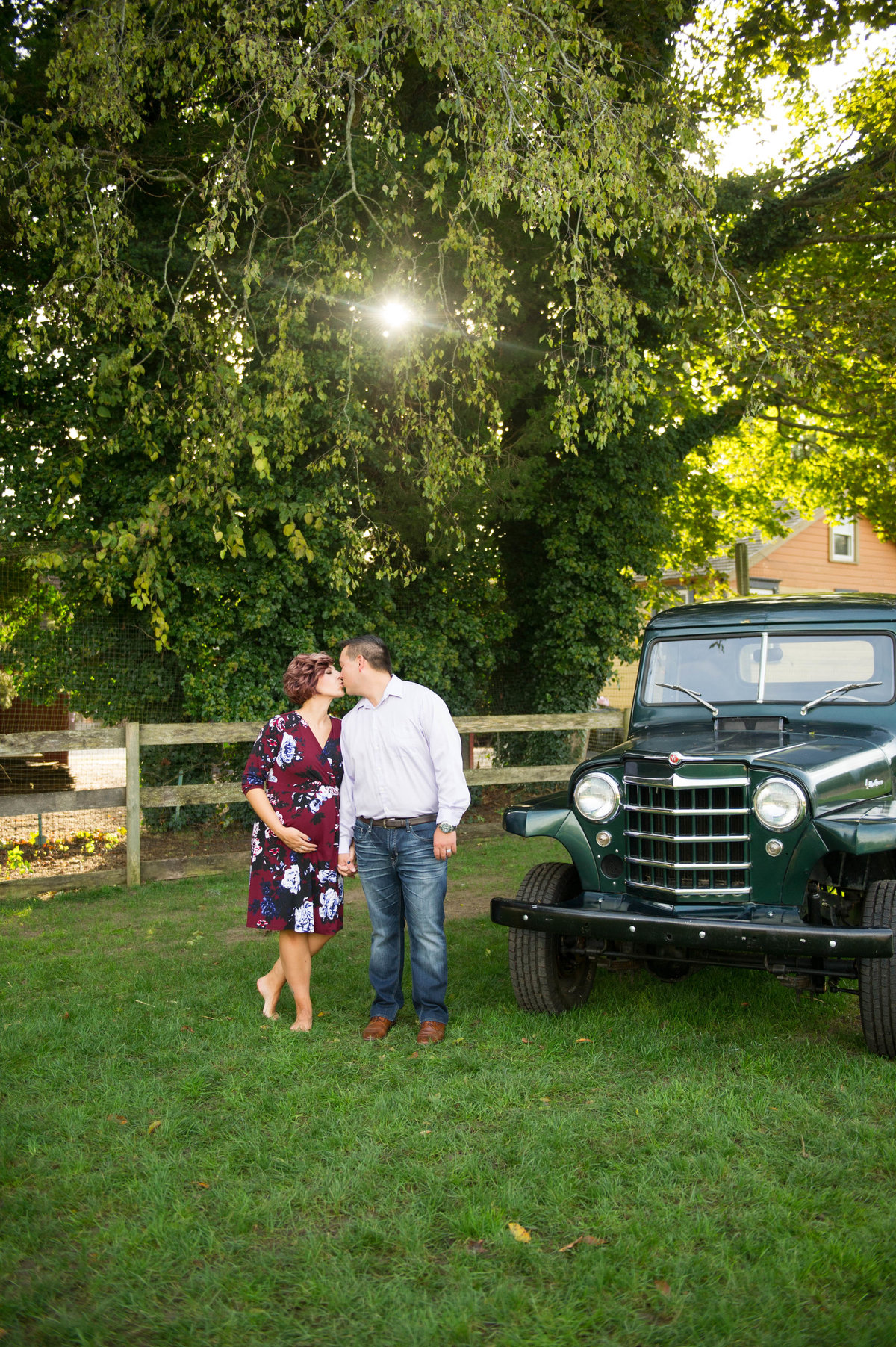 pregnant couple with classsiv green truck