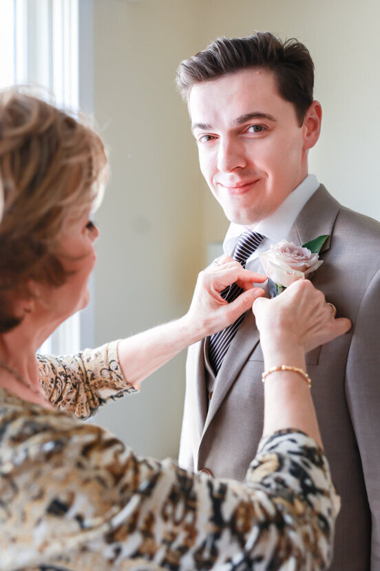 mother-putting-flower-on-groom