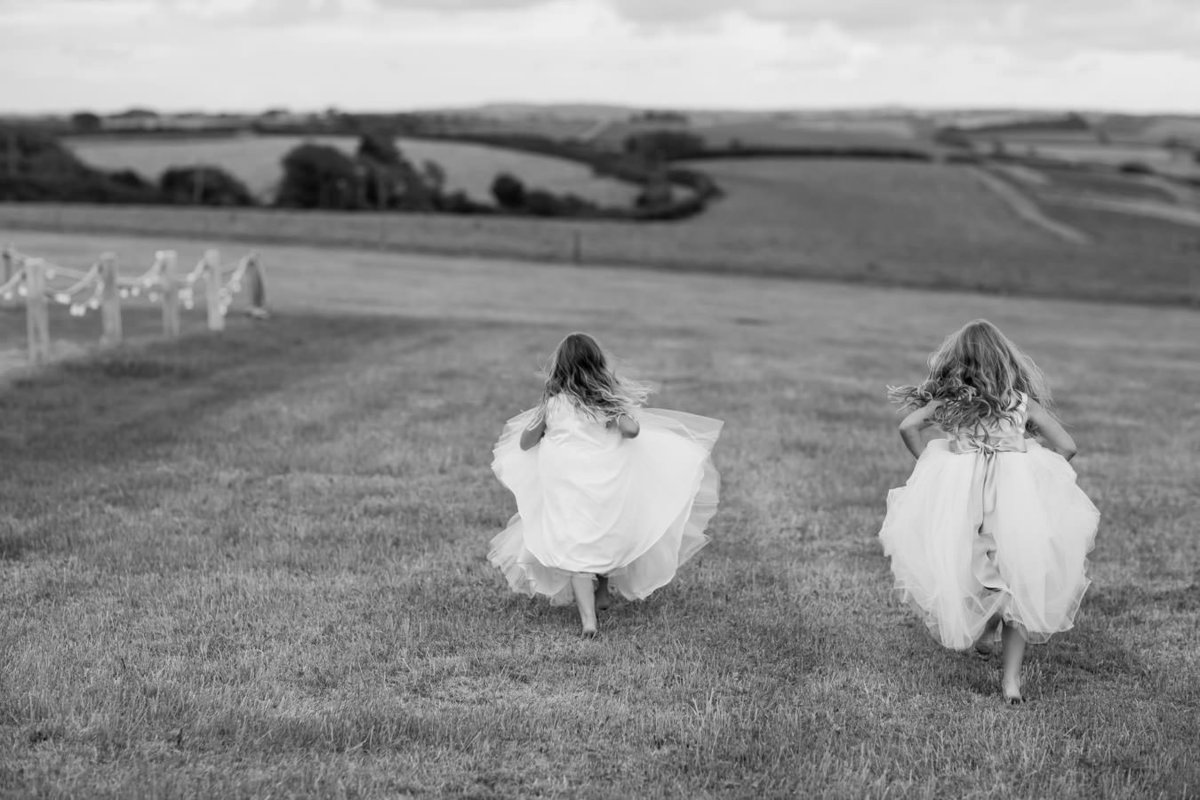 Flower girls running at Wedding in Devon