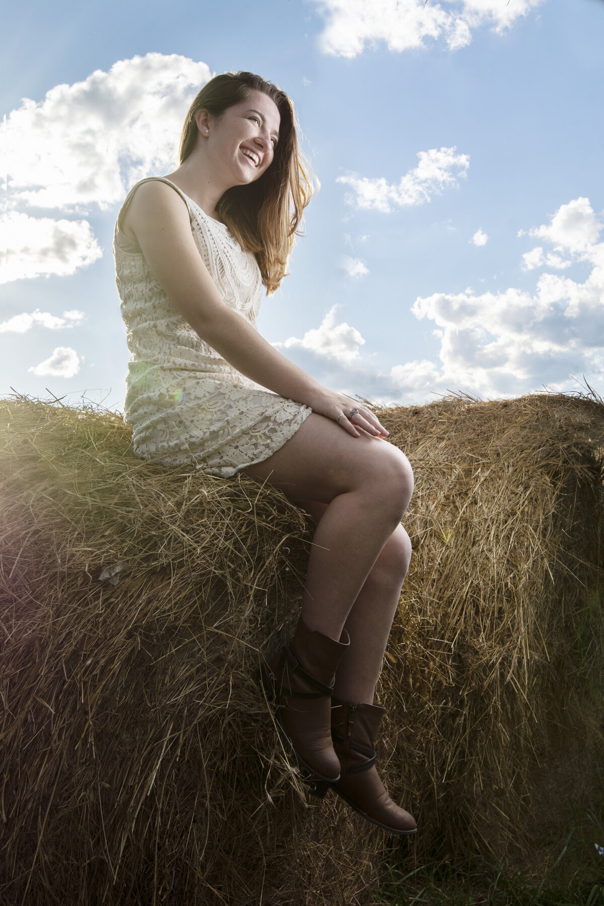 Megan sitting on hay bale