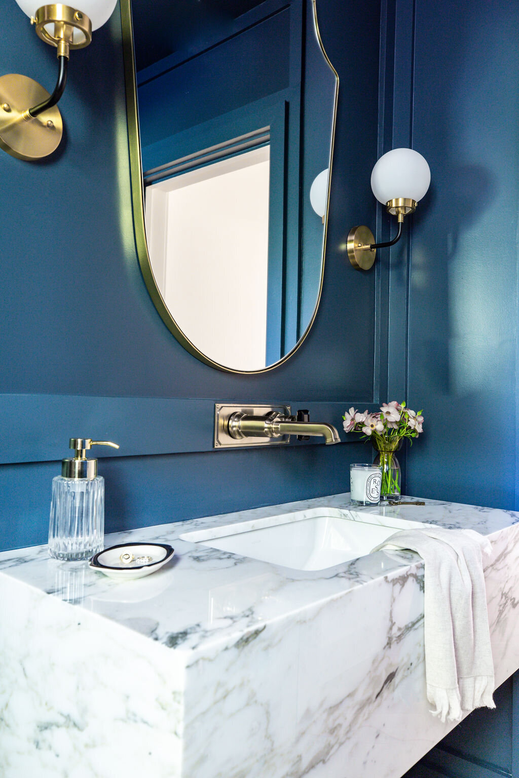 Masculine Powder Room  with Corchia marble floating vanity, Italian Shield mirror, Brizo Invari wall mounted faucet