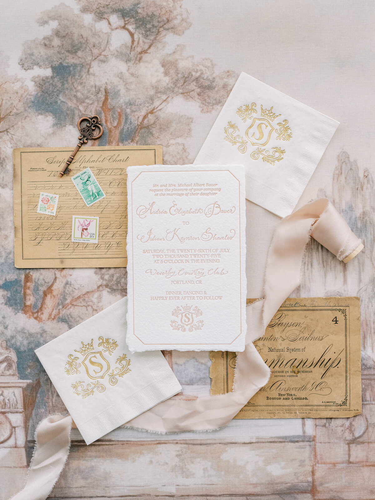 Wedding flatlay featuring luxury wedding monogram and custom calligraphy details with ribbon and stamps representing full service design and calligraphy by Life in Letters.