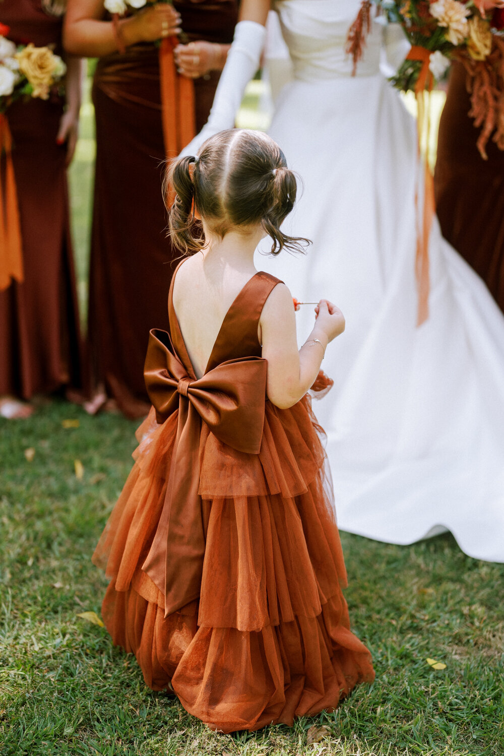 flower-girl-with-pigtails-in-rust-satin-dress