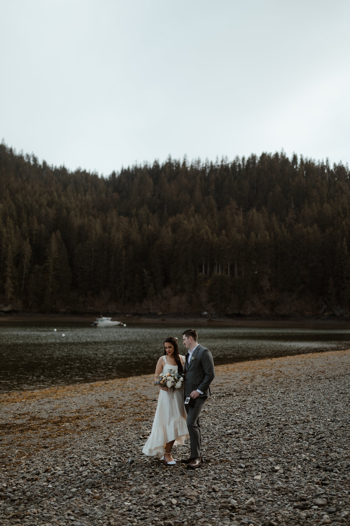 bride and groom posing on beach