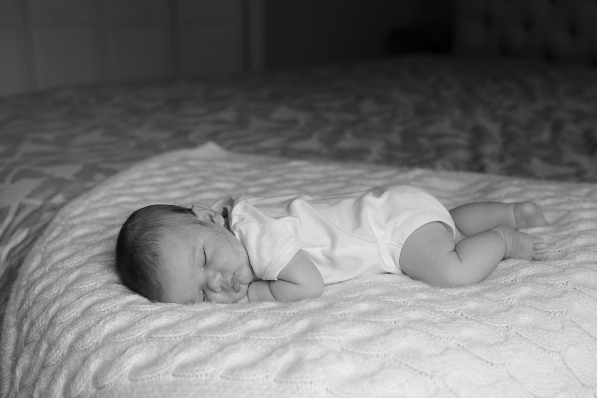 newborn lies on a blanket during Boston newborn session.